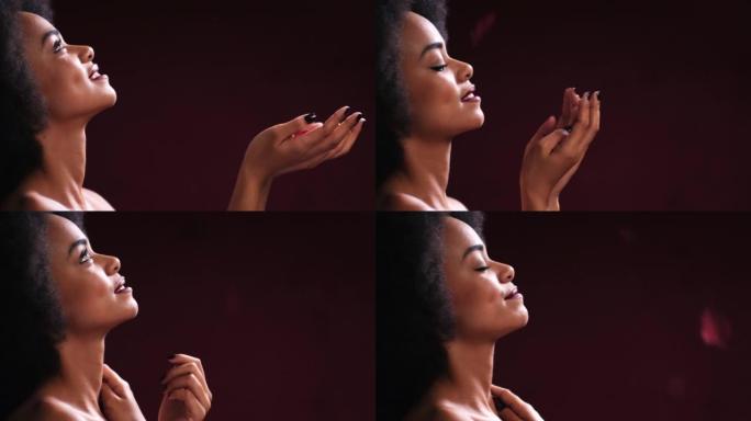 美丽，非洲裔和黑人妇女在工作室里用玫瑰花瓣模型制作情人节浪漫或魅力。性感，热情和护肤的非洲女孩在黑暗