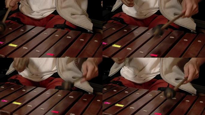木琴演奏者，演奏木琴的男音乐家，木琴的木棒被木槌击中。特写。