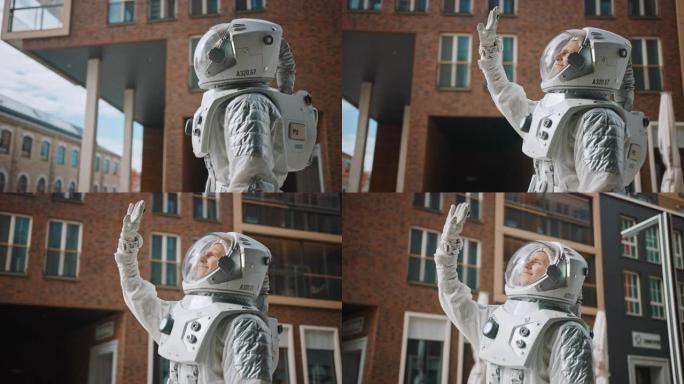 一个自信英俊的宇航员看着明亮的蓝天，用手遮住太阳的低角度镜头。穿着未来派西装的人，手上有技术面板。现