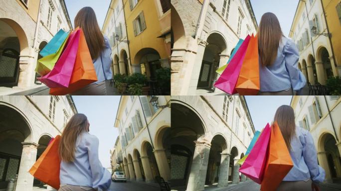 一位年轻的无忧无虑的微笑女人带着五颜六色的袋子去购物，她对在旧城区销售期间的购买感到满意。概念: 时