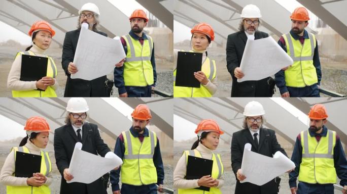 建筑师与建筑工人交谈，展示了在户外建筑区域行走的蓝图