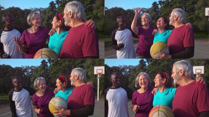 一群老年人拥抱并微笑着在户外篮球