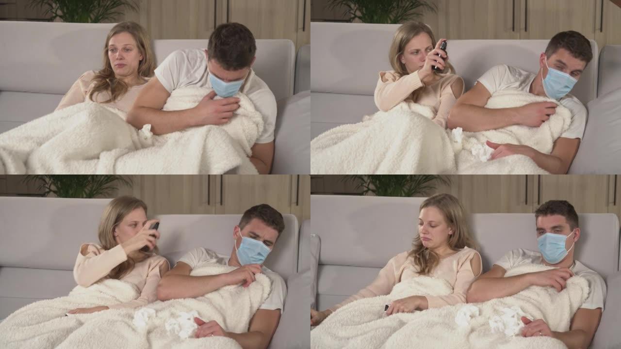 特写。两人在电视上盖着毯子，而患有流感的人打喷嚏