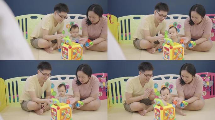 亚洲父母在女儿玩玩具时照顾她