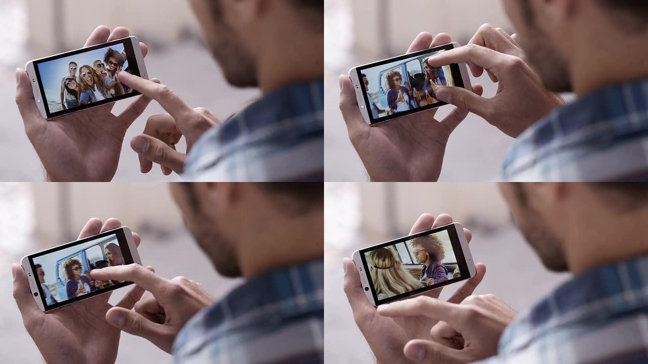 男人看着智能手机上朋友的照片