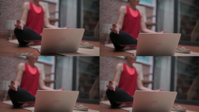亚洲中国中年女性练习视频在线训练哈塔瑜伽教练现代笔记本电脑冥想苏哈萨纳姿势放松呼吸轻松座椅姿势健身房