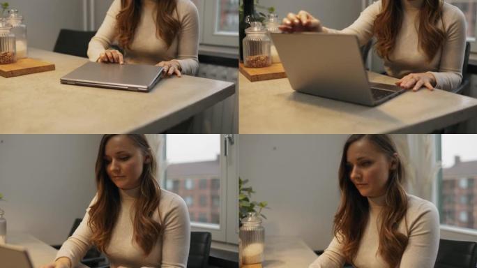 女人打开笔记本电脑开始工作