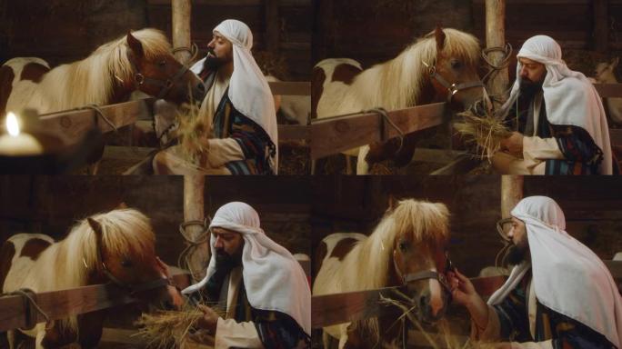 约瑟夫在马stable里喂马