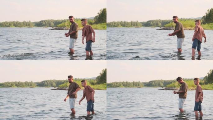 男人和男孩扔石头站在湖里