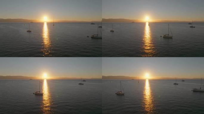 海上壮丽的日出。在希腊科孚岛升起的太阳的背景下，在海上的许多游艇上飞行