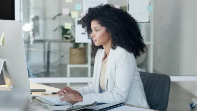 女商人独自在办公室工作时打字电子邮件，看上去很困惑，并在台式计算机上思考。女性企业专业人士、助理或秘