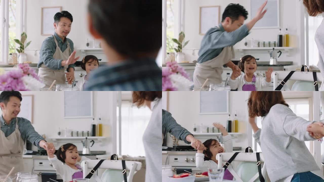 快乐的亚洲家庭在厨房跳舞，让孩子们高五岁，与父母一起跳舞，享受激动人心的周末在家庆祝活动4k镜头
