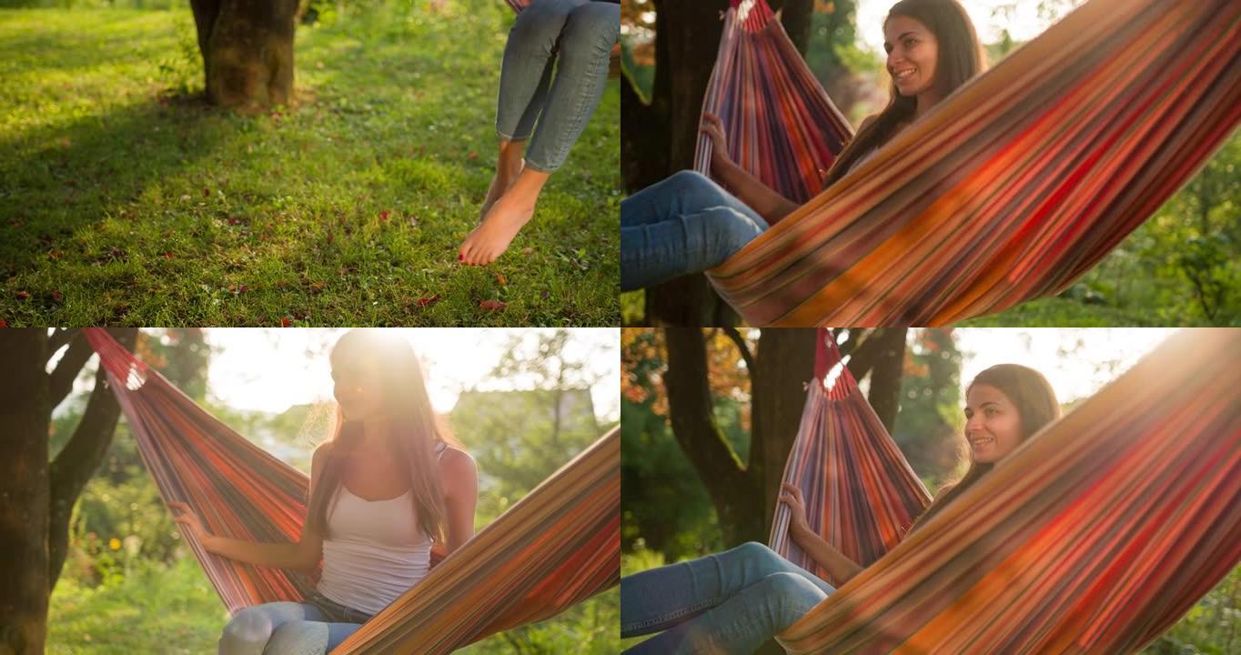 开朗的年轻女子在后院树下的吊床上摇摆