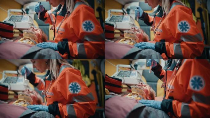 女性专业急救护理人员在救护车上与受伤病人一起前往医疗保健医院。紧急护理助理检查并使用手电筒检查颈部有