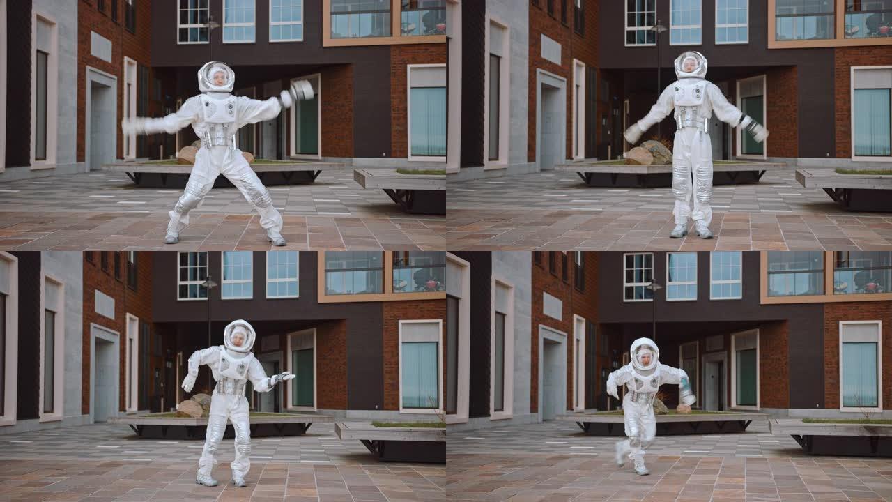 穿着宇航服的英俊男子正在附近跳舞。宇航员很高兴，并做出了创造性的机器人动作。成功的太空人穿着白色的未