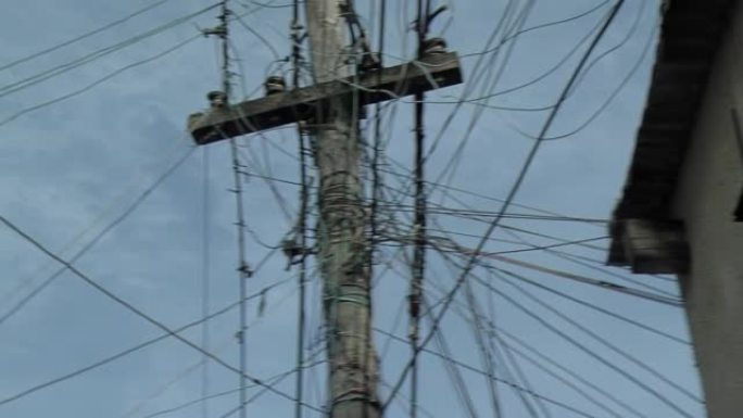 阿根廷布宜诺斯艾利斯一个棚户区的电线杆上凌乱的电力线和通信线路。