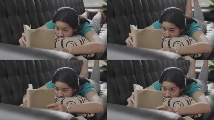 亚洲少女在家时读一本非小说类书籍。她翻开学习书的一页。学习绿色教育的女孩。