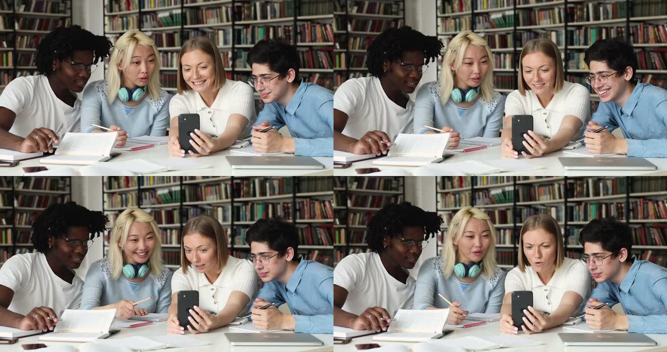 多元化的学生同伴坐在图书馆里玩得开心