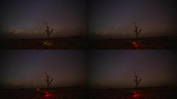 WS延时摄影师在繁星点点的夜空下设置相机，纳米比亚，非洲