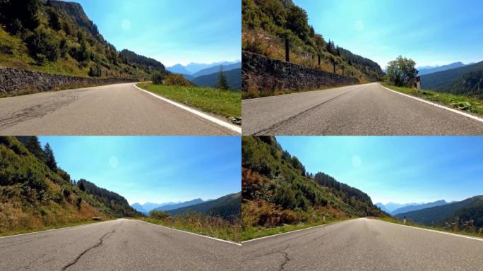 在美丽的晴天，在空旷的山路上驾驶汽车穿越风景如画的风景