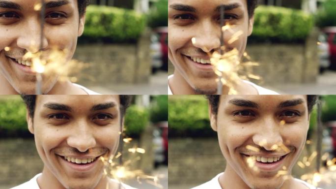 4k视频片段，一个英俊的年轻人独自站在城市外面玩烟火