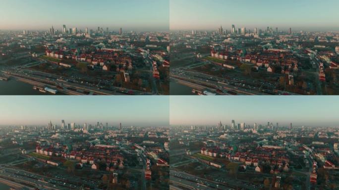 无人机在华沙城市上空移动，在晴朗的蓝色日出天空下，宁静的城市轮廓线背景下。