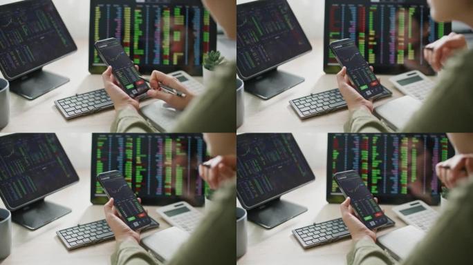 女商人在智能手机和计算机屏幕上观看金融市场信息