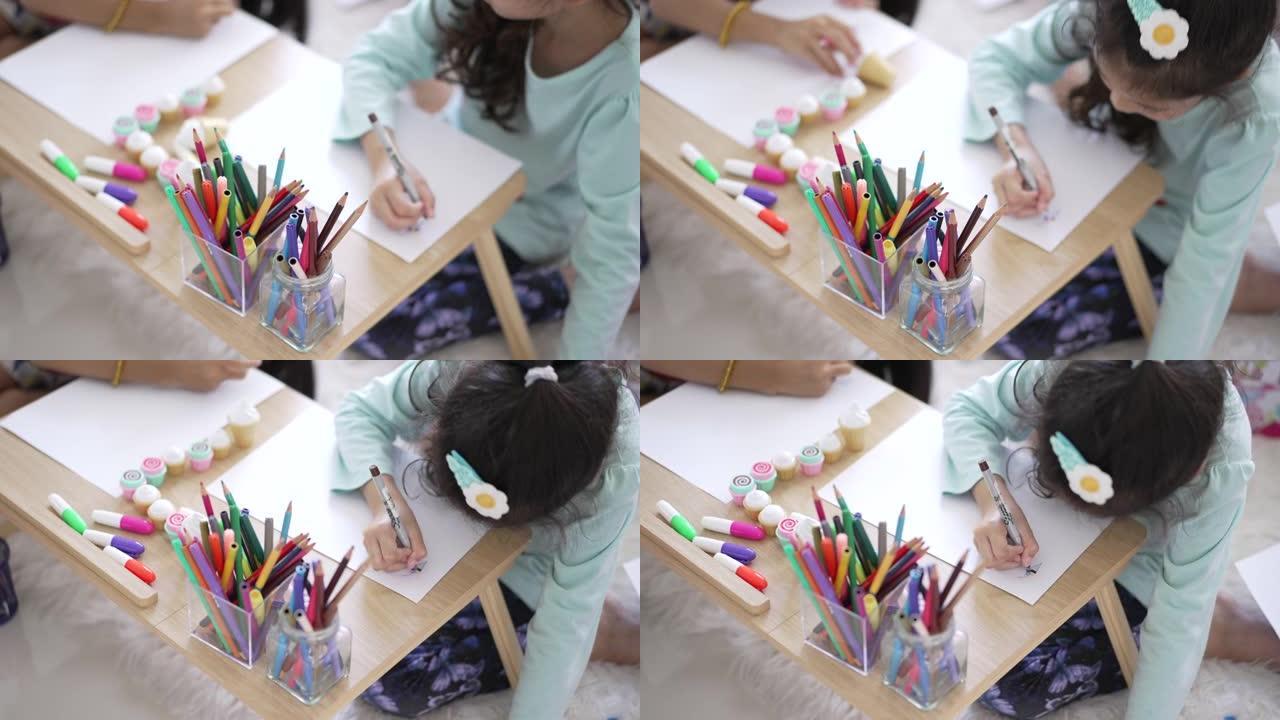 小女孩在家里的木桌上画家庭作业的特写