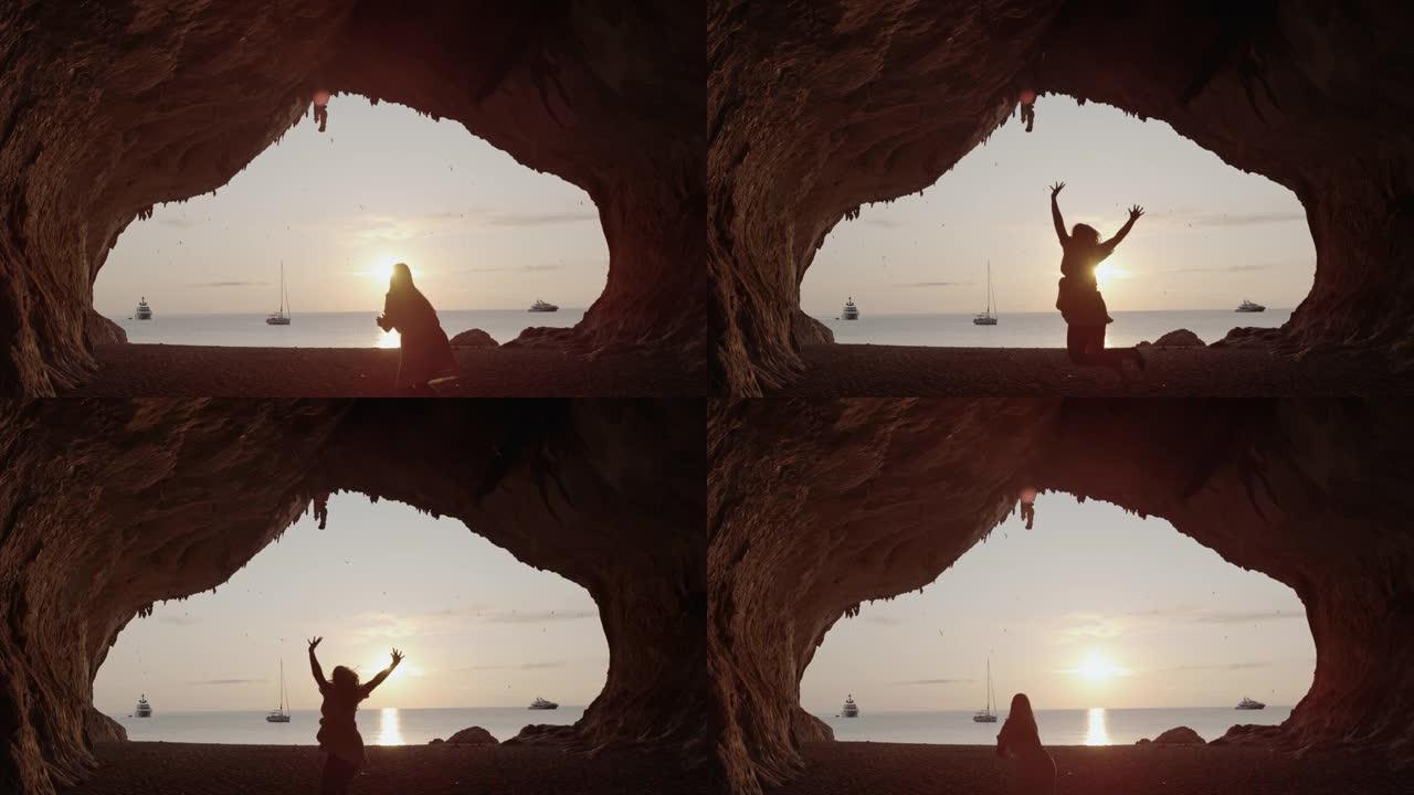 一个女人在海滩上跳跃的超级SLO MO视图，Cala Luna，撒丁岛。意大利。