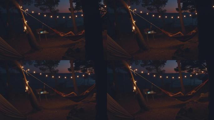 黄昏时，SLO MO女人在夏季露营地的吊床上放松