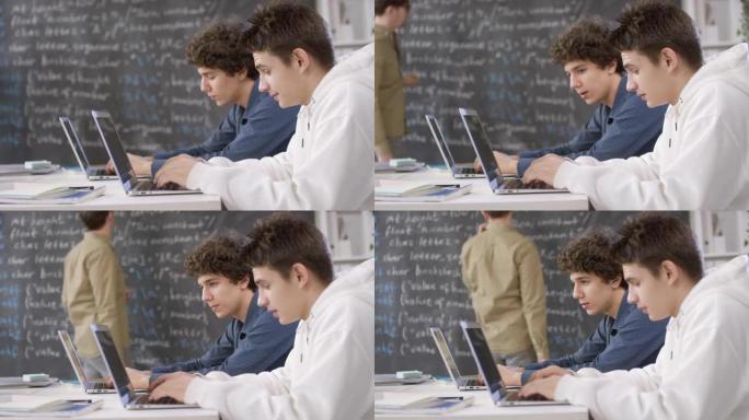 男生在电脑课聊天