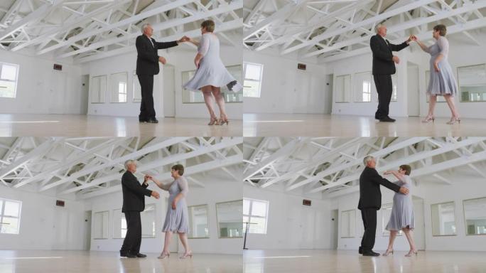 高加索高级夫妇在舞厅里一起跳舞