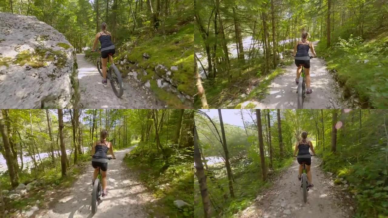 年轻的女游客在Bovec的风景秀丽的森林小径上骑电动自行车