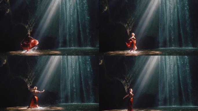 瀑布洞里跳舞的女人泼水穿着漂亮的衣服享受自然舞蹈感受精神自由4k