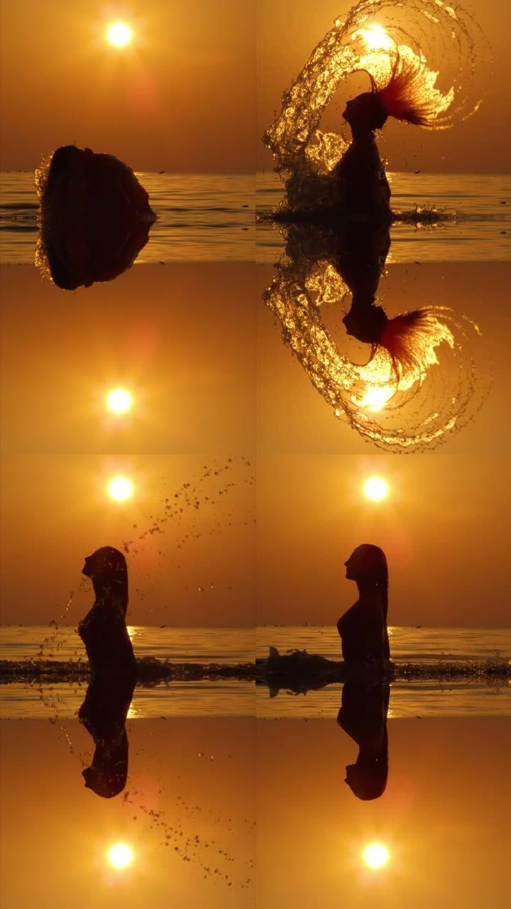 慢动作垂直: 年轻女子在日落时用头发溅海水