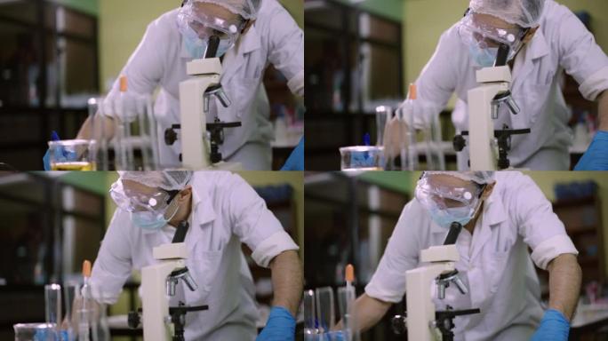 科学家使用显微镜并在实验室中与病毒进行笔记实验