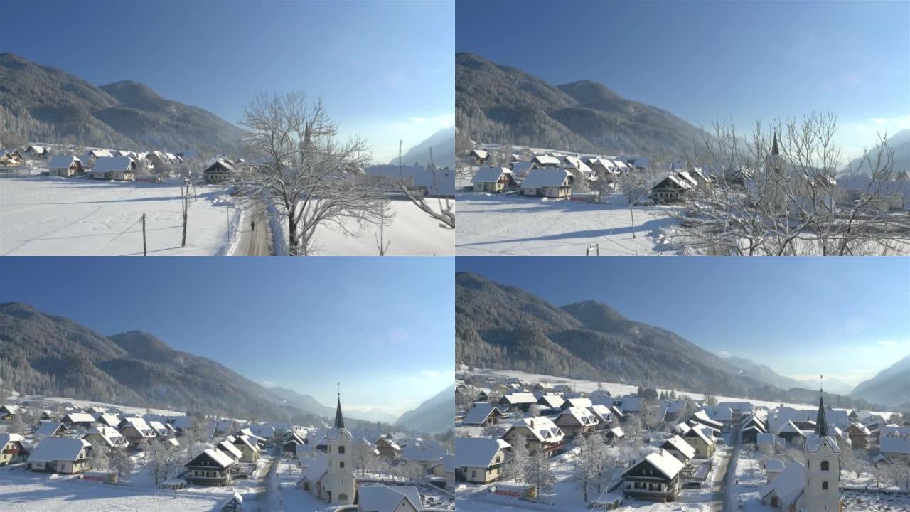 空中: 新鲜降雪后，高山村庄的美丽阳光明媚的冬天早晨