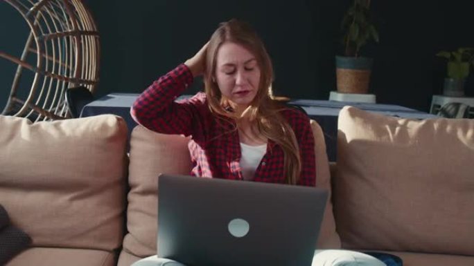 应对压力。美丽严肃的年轻白人女商人用笔记本电脑在家工作。