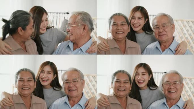 快乐的亚洲民族家庭微笑着拥抱在家里的相机，肖像