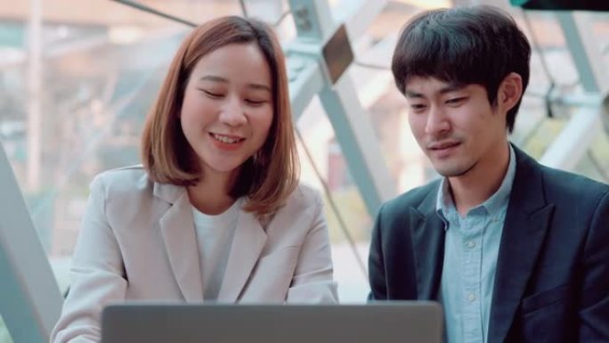 年轻的商业夫妇一起使用笔记本电脑。