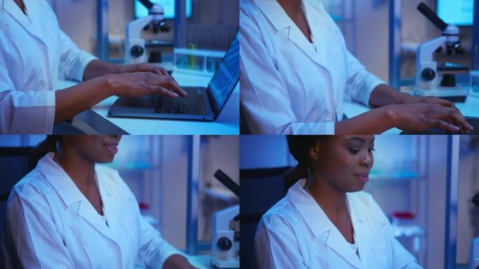 一位年轻的非裔美国女科学家在笔记本电脑上的现代实验室工作，而相机从她的手移到她的脸上