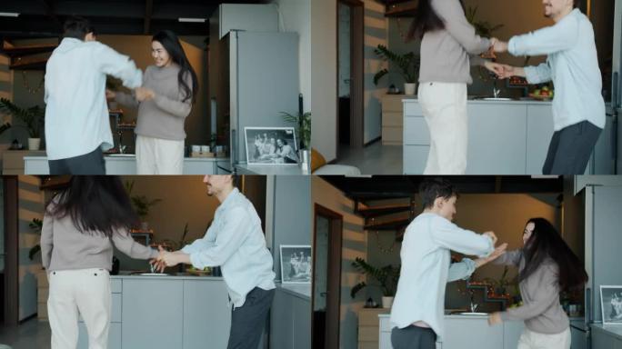 在现代厨房里，快乐的女孩和男孩在室内跳舞和跳跃的慢动作。
