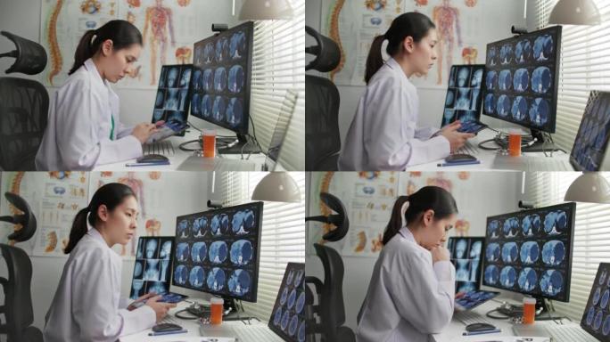 多莉拍摄的女医生在办公桌上处理x射线图像