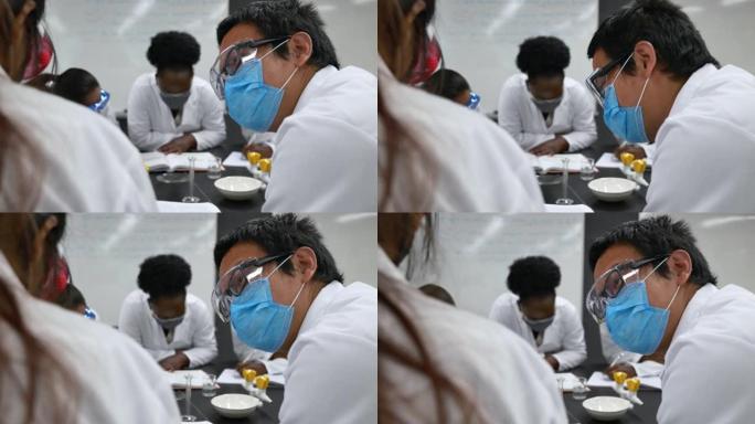 实验室里戴口罩的多民族学生。