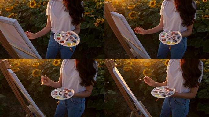 慢镜头年轻女子在向日葵地中间作画