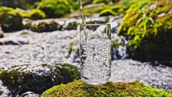 SLO MO将淡水倒入岩石上的水杯中，冲着急流