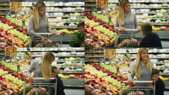 带着购物车的快乐母子的真实照片正在超市一起购买杂货时选择要购买的食品。