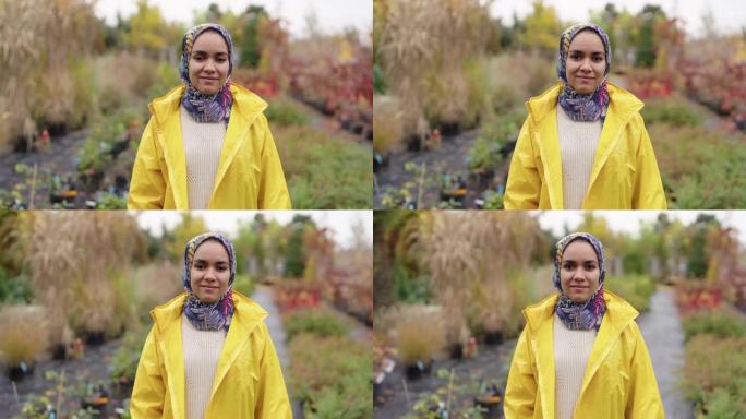 一名年轻的穆斯林妇女站在苗圃的肖像
