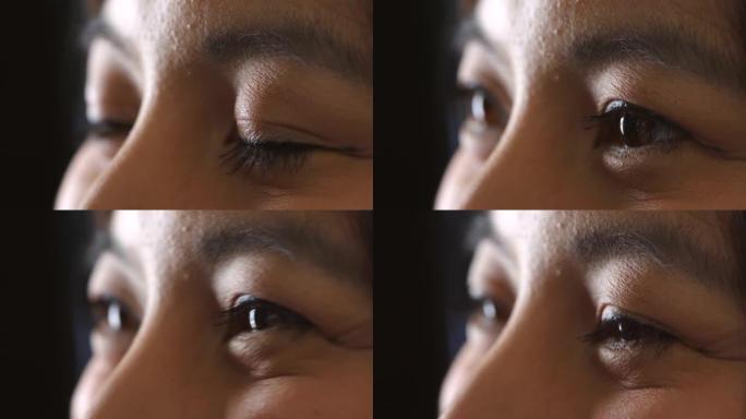 在处方眼镜或隐形眼镜的视力测试中，与验光师交谈的亚洲女性的眼睛特写。一个女性聊天微笑的脸的头像