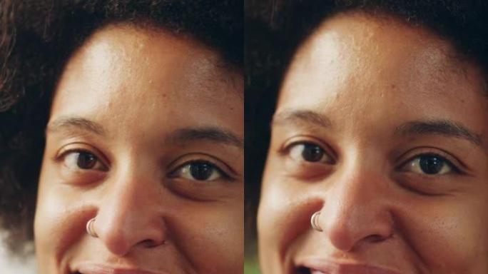 一个快乐的年轻拉丁人的垂直肖像，棕色的眼睛，非洲的头发和鼻子穿孔，为相机摆姿势。美丽多样的多种族黑人